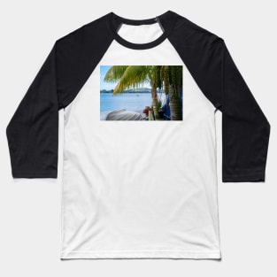 Tropical garden frames view over white clinker dinghy to bay with stand-up paddle-boarder in distance. Baseball T-Shirt